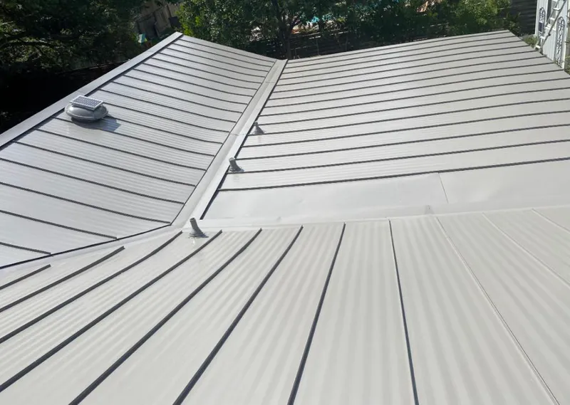 Solar attic fan installed on a metal roof for Roof Ventilation in Kirtland